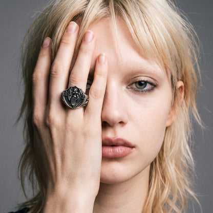 Blonde model with her hand over half her face wearing the Archangel Michael signet ring