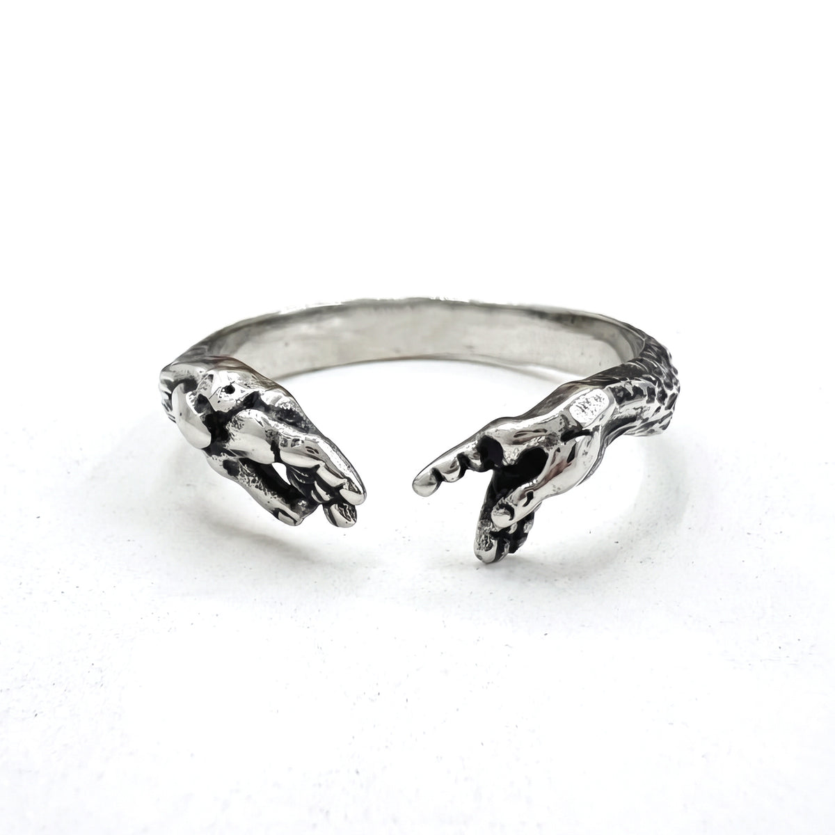 Ascension hands of God open stainless steel ring, high angle view on white background
