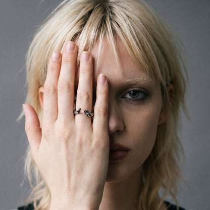 Blonde model with her hand over her face wearing the Ascension hands of God ring, vintage film photo