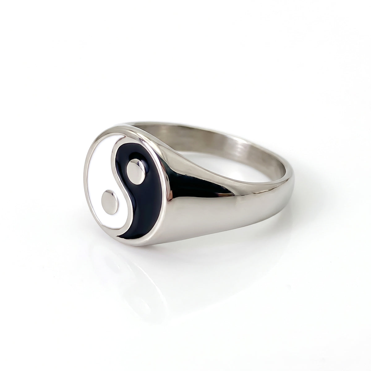 Eclipse yin-yang signet ring in stainless steel, side view showing the smooth band on white background