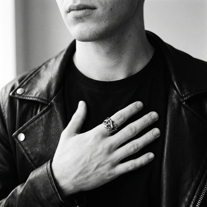 Black and white photo of a hand pressed to a chest wearing the Penance crown of thorns ring