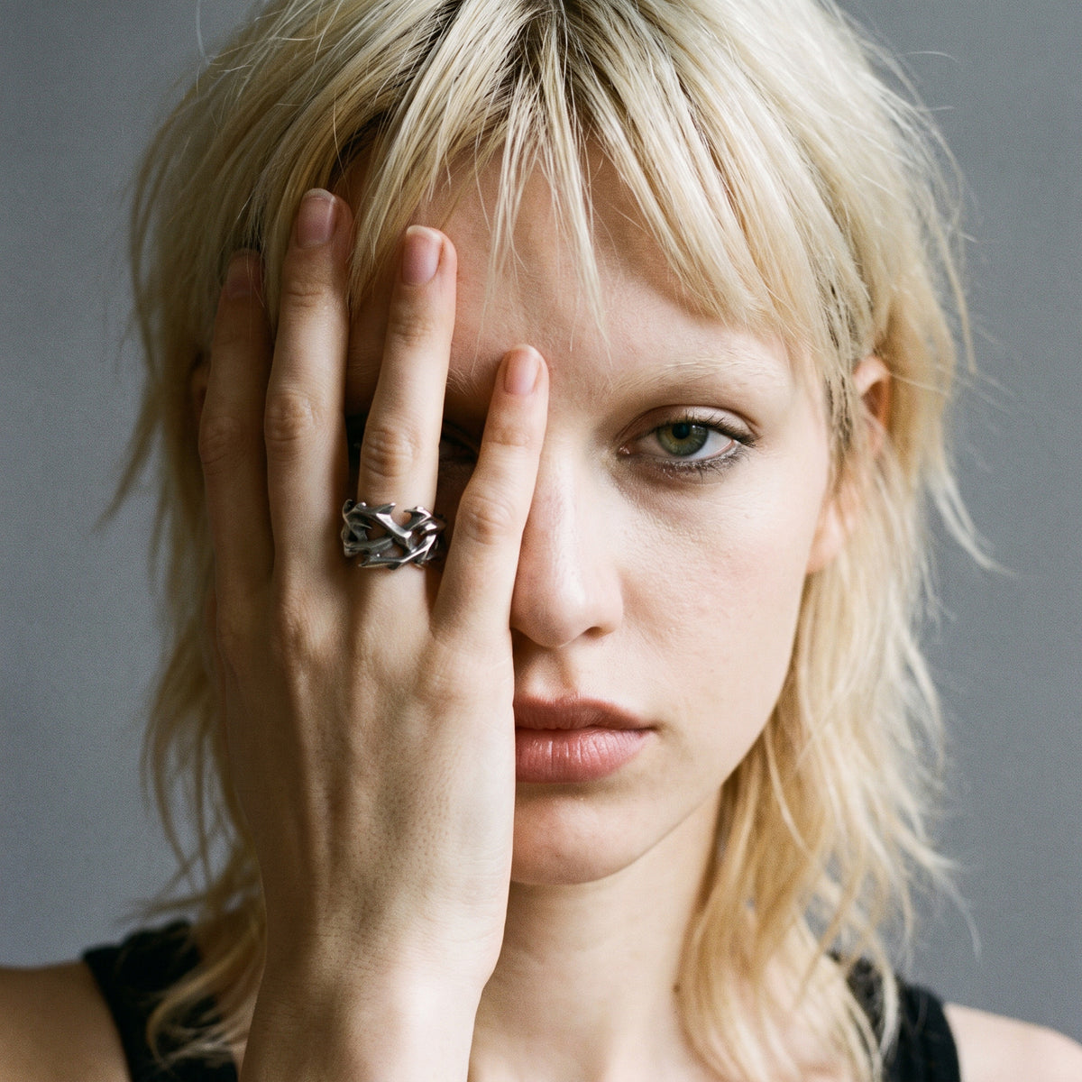 Blonde model with her hand over half her face wearing the Penance crown of thorns ring