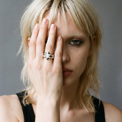 Blonde model with her hand over her face wearing the Polaris six-point star ring, vintage film photo