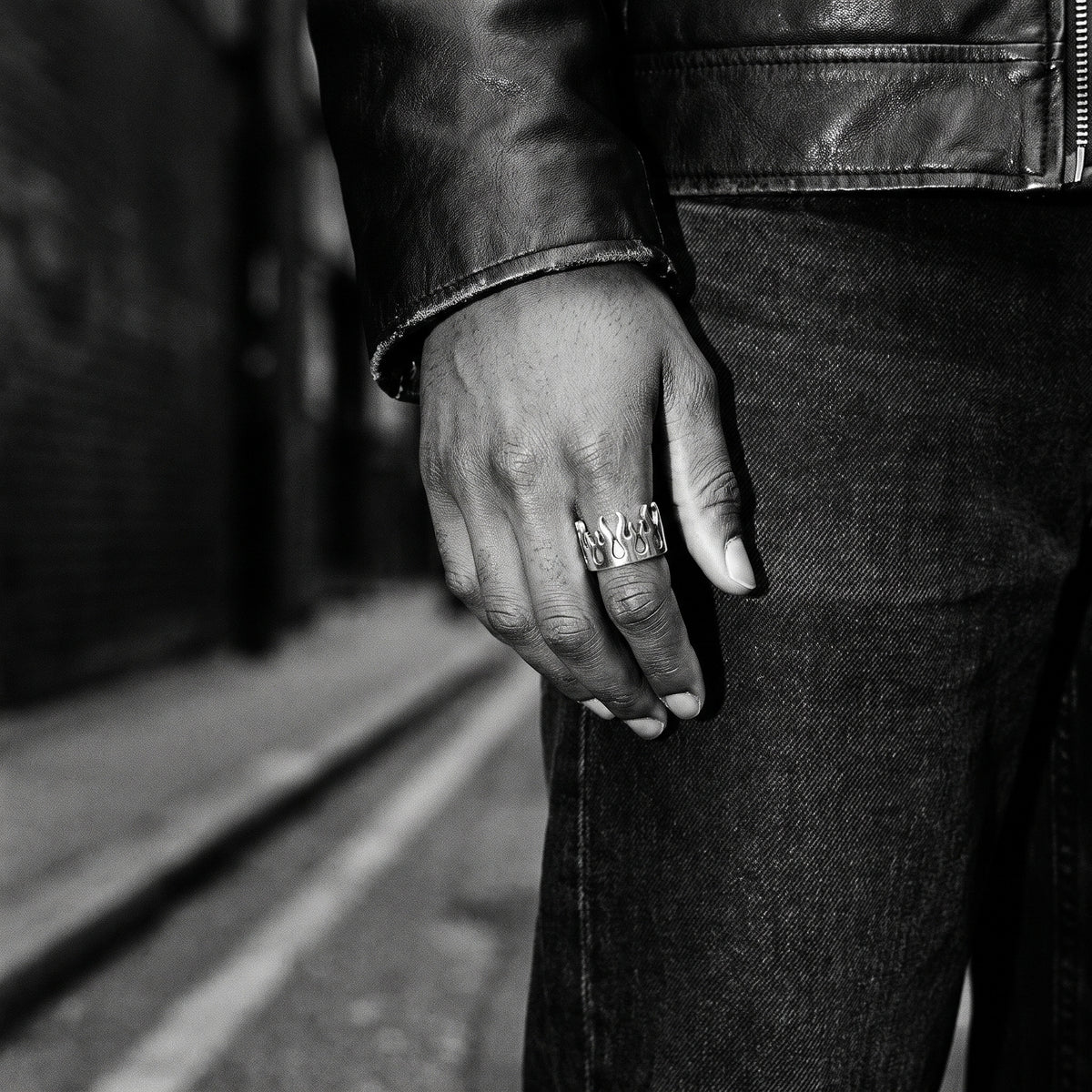 Pyre Flame Open Band Ring worn on a man's hand, black and white film photograph