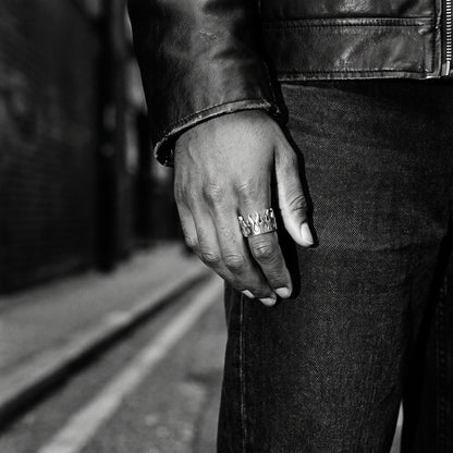 Pyre Flame Open Band Ring worn on a man's hand, black and white film photograph