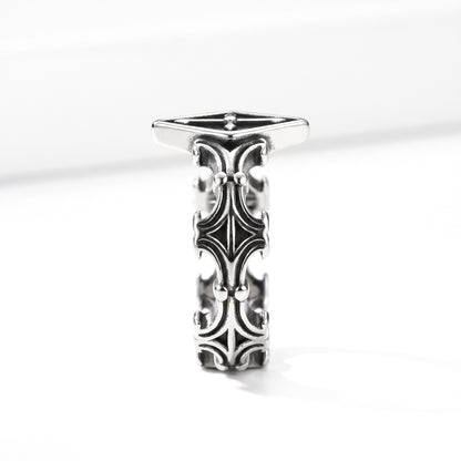 Relic rhombus cross ring in stainless steel, side profile showing the scrollwork band on white background