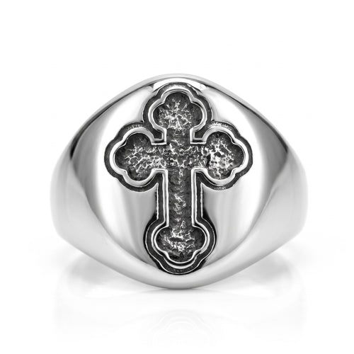 Reliquary Cross Amulet Ring, front view: stainless steel signet ring with a polished oval face and a dark antiqued trefoil cross, on white background