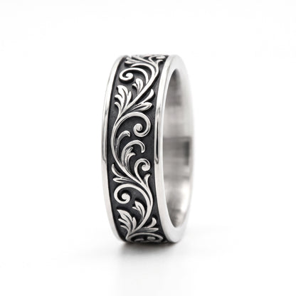 Skald Viking scrollwork band ring in stainless steel, side view showing the scroll pattern on white background