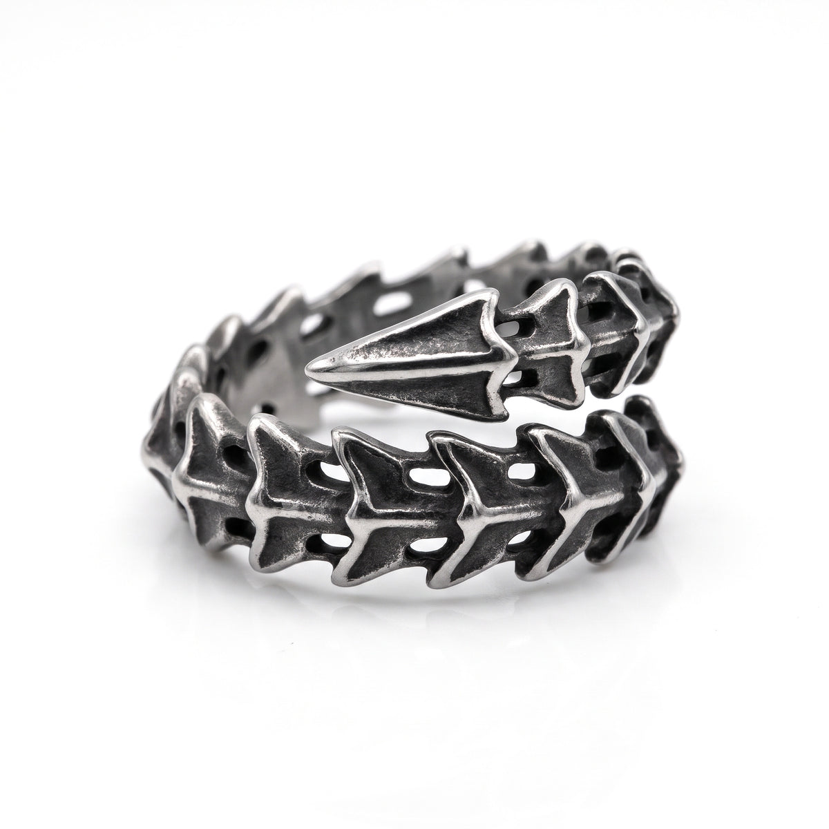 Vertebra dragon bone wrap ring in stainless steel, angled view from above on white background