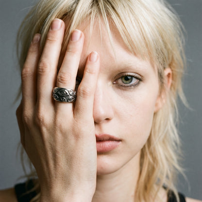 Blonde model with her hand over her face wearing the Watcher eye ring, vintage film photo